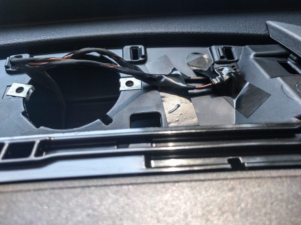 Tape the two wires to the dash so they don't rattle while you're driving. Then, replace the grille and you're done. 