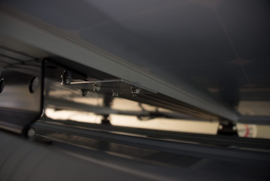 Aluminum plate to hold solar panels in place on VanTech roof rack crossbars