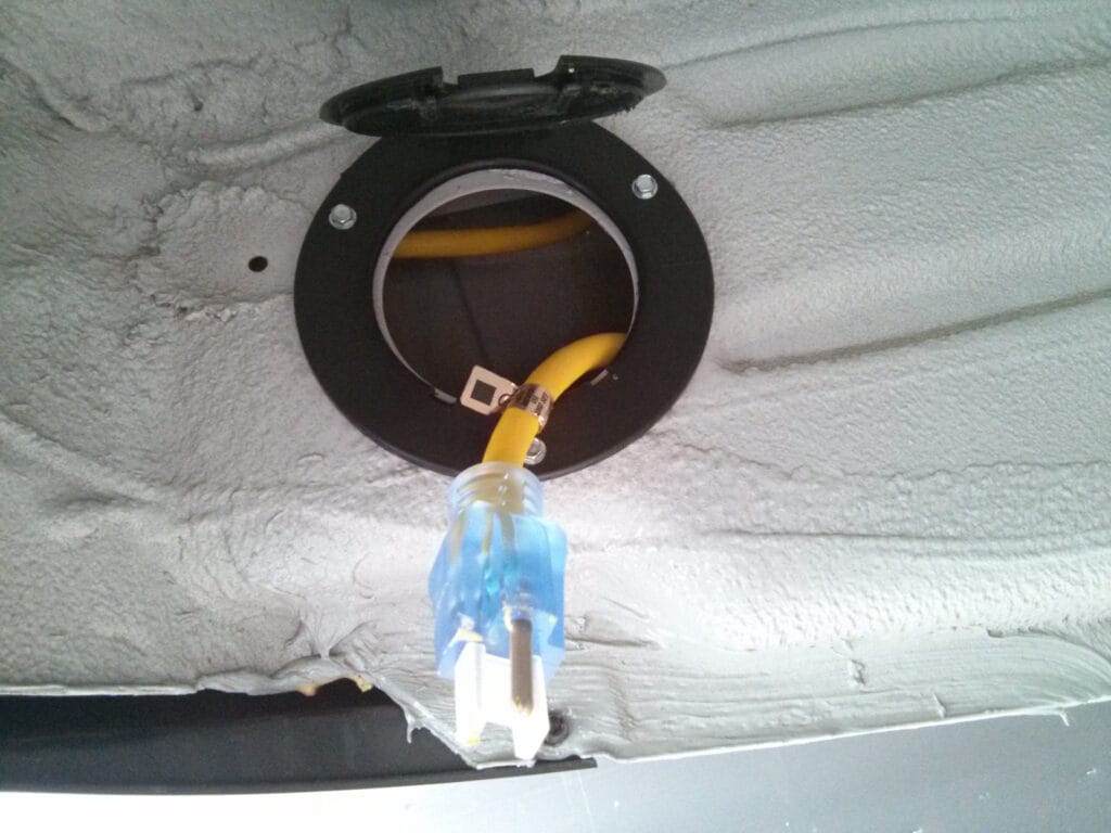 Under the van, there are large holes in the rocker panel. Perfect for a cable with a hinged cover.