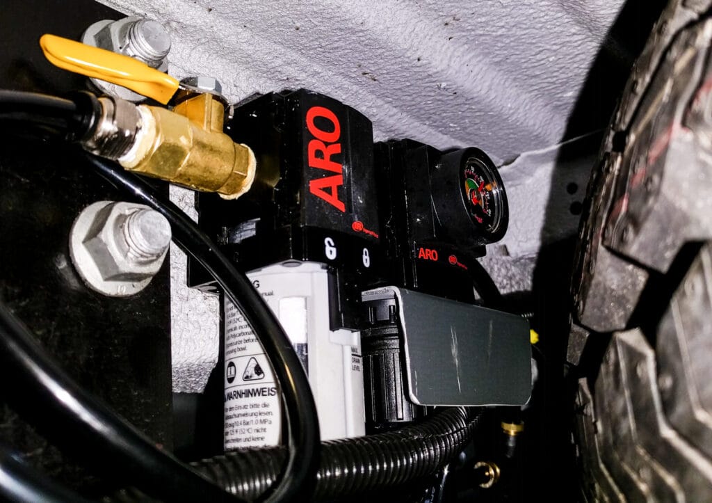 Air filter and pressure reducer next to spare tire