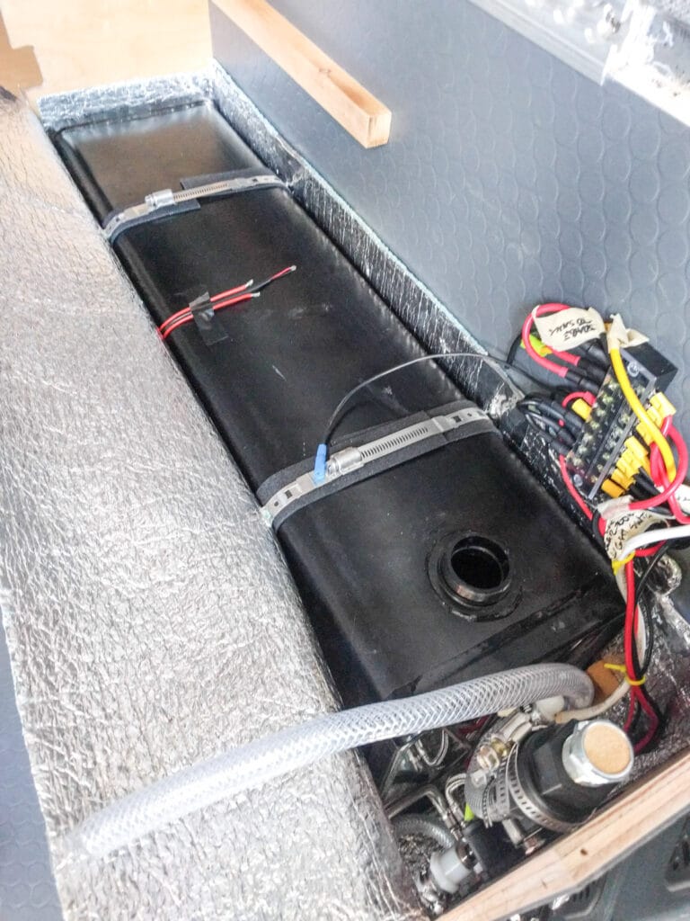Cold tank held in place with very long hose clamps
