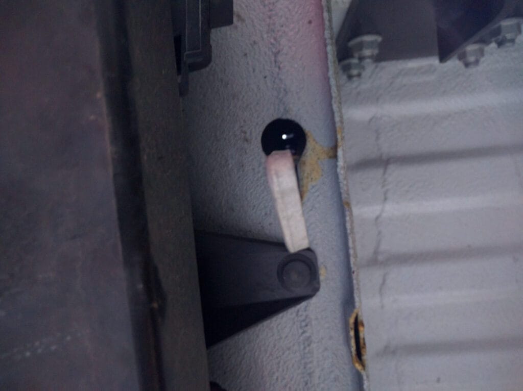 The hook that holds the spare tire holder in place (seen from below)