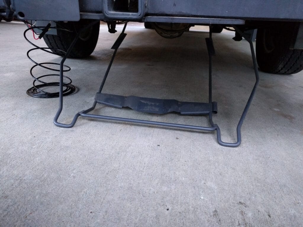 The spare tire holder lowered to the ground