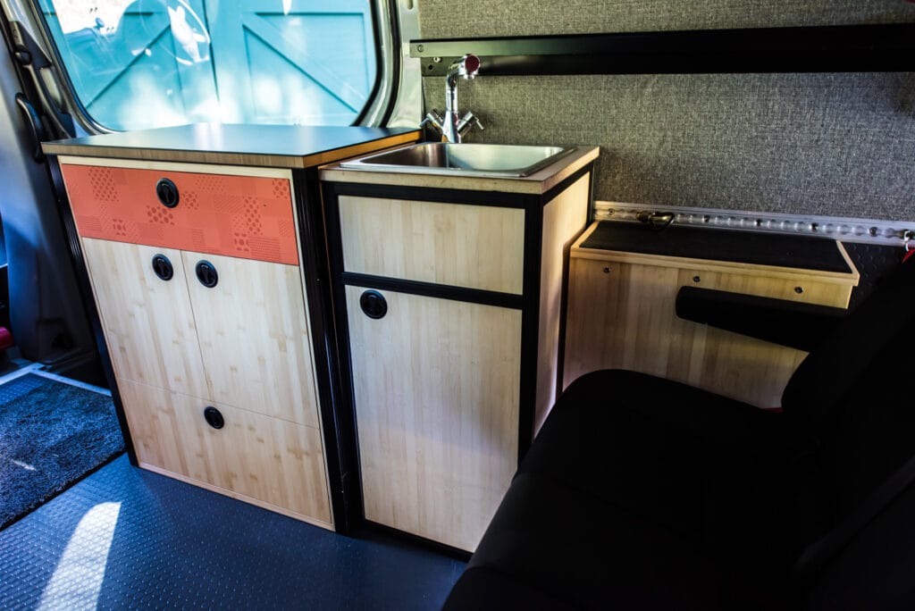 Sliding door cabinet, sink cabinet, hot water tank (next to bench seat)