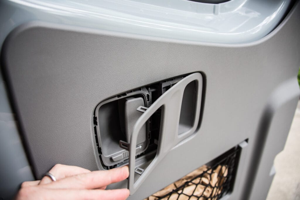 The trim surrounding the door handle is flimsy, so be careful when you remove it.