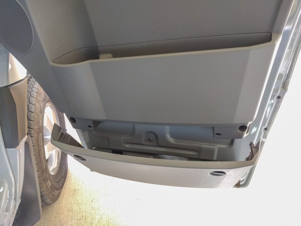 Door panel removal - two more T20 bolts behind the lower storage bin