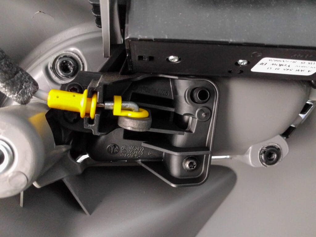 Door panel removal - unhook the door catch cable by first sliding the yellow cylindrical piece out of its holder, unclipping the smaller yellow piece from the wire (without removing it from the actuator arm), then lifting the l-shaped cable end out from the actuator