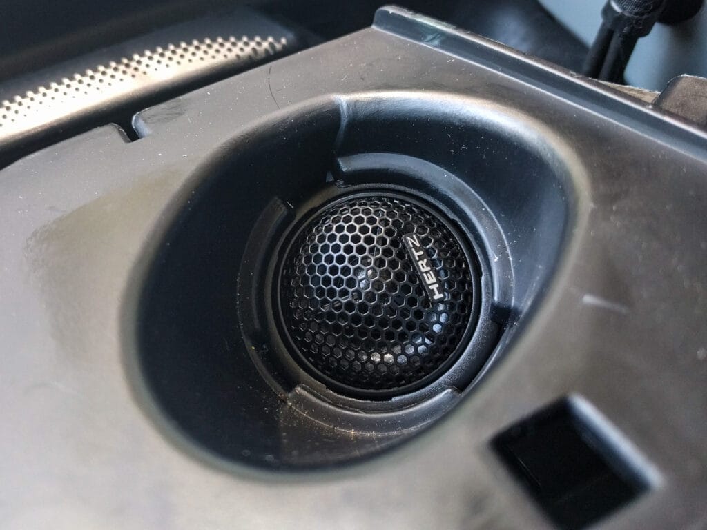 Pull the tweeter wire through to the underside of the tweeter surround, then crimp on butt connectors to join the tweeter wires to the ones coming from the crossover. Now you can push the tweeter into the underside of the surround. It should just clip in place.