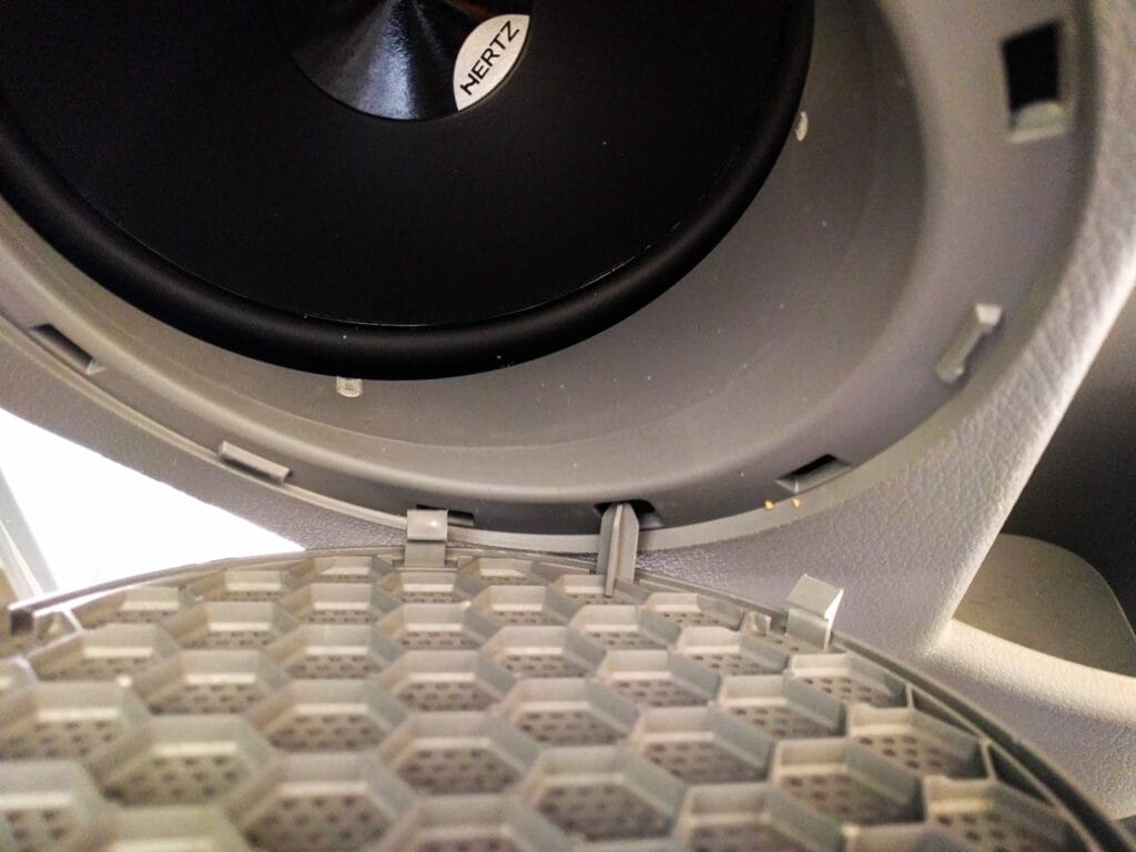Check that the front of the speaker clears the plastic edge of the door panel.