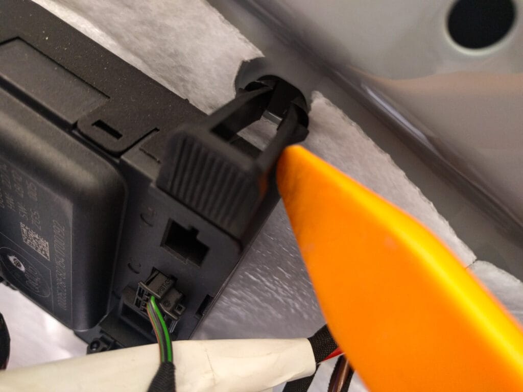 On the driver's door, you'll need to remove the control box for the electric windows. There are two clips on the front edge, then the unit slides forwards to release from the door.