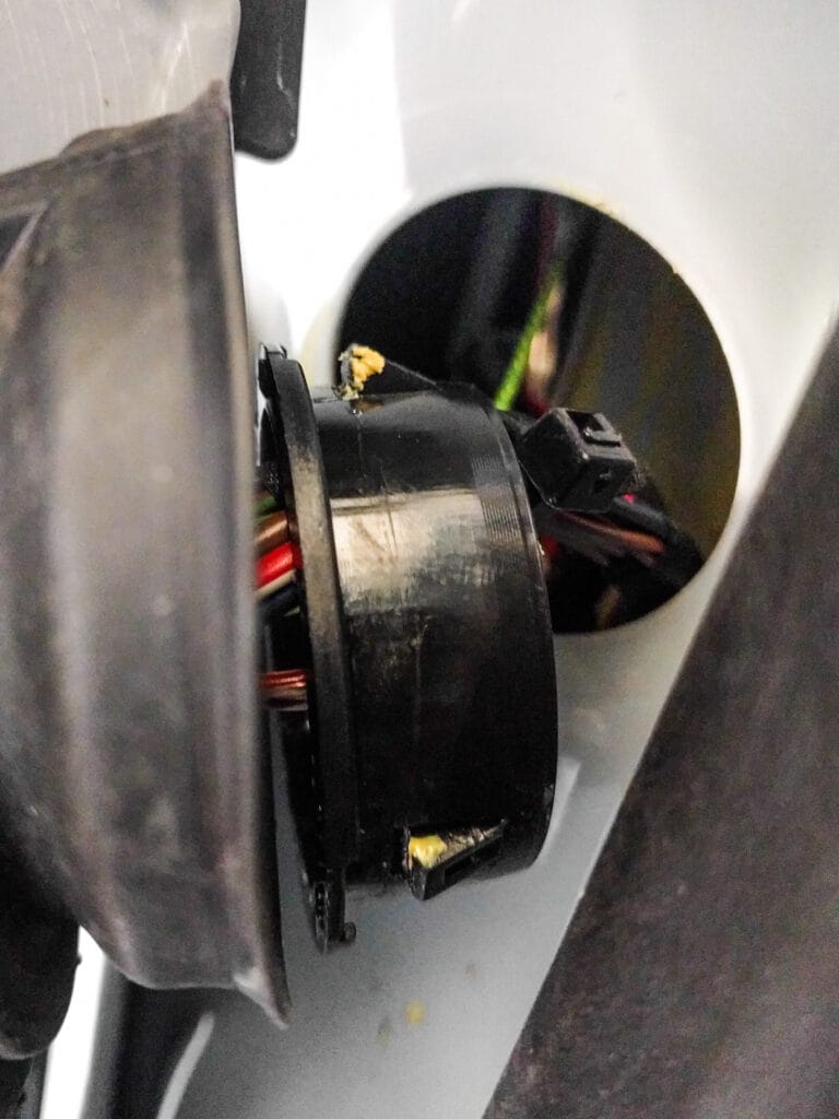 Make it easier to thread the wire through by pulling the rubber boot off from the A pillar. To re-install, first remove the plastic clip from the a-pillar metal (three tabs around its circumference), then re-attach the plastic clip to the rubber boot. Now clip the whole thing back into the hole in the A pillar.