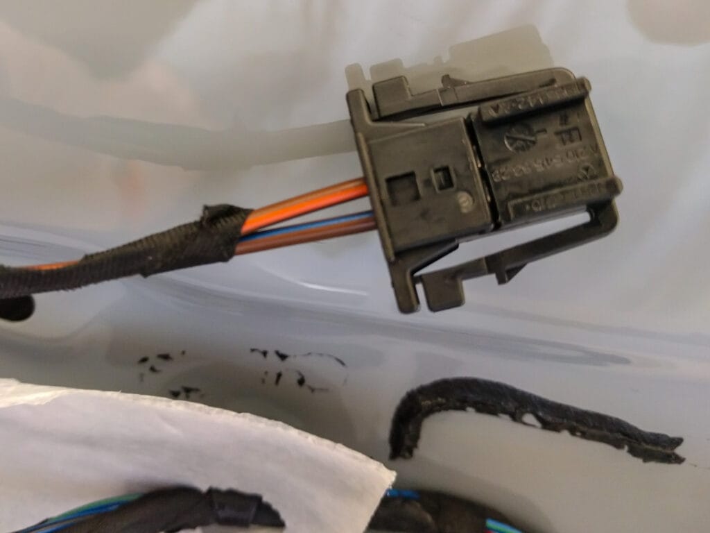 Cut the end off the original speaker wire in the door. Use butt crimps to connect this to the input on the crossover. Driver side: Brown/purple is +; Passenger side, brown/orange is +