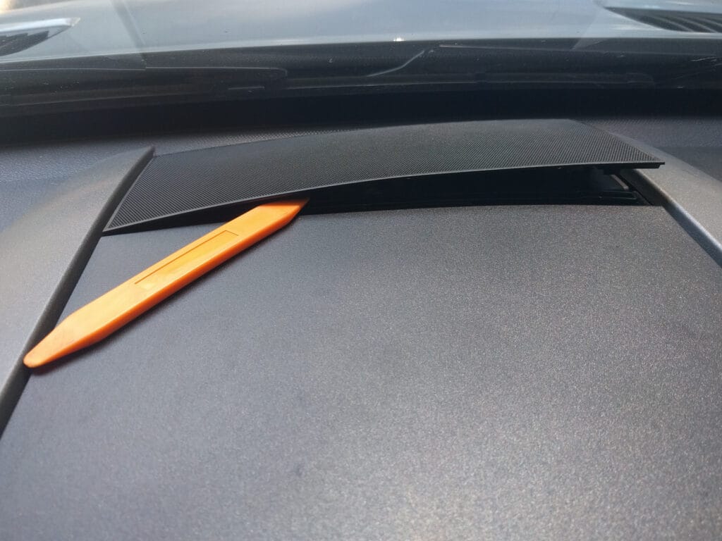 The central "voice coil" speaker sits under this grille in the middle of the dash. Pry it off.