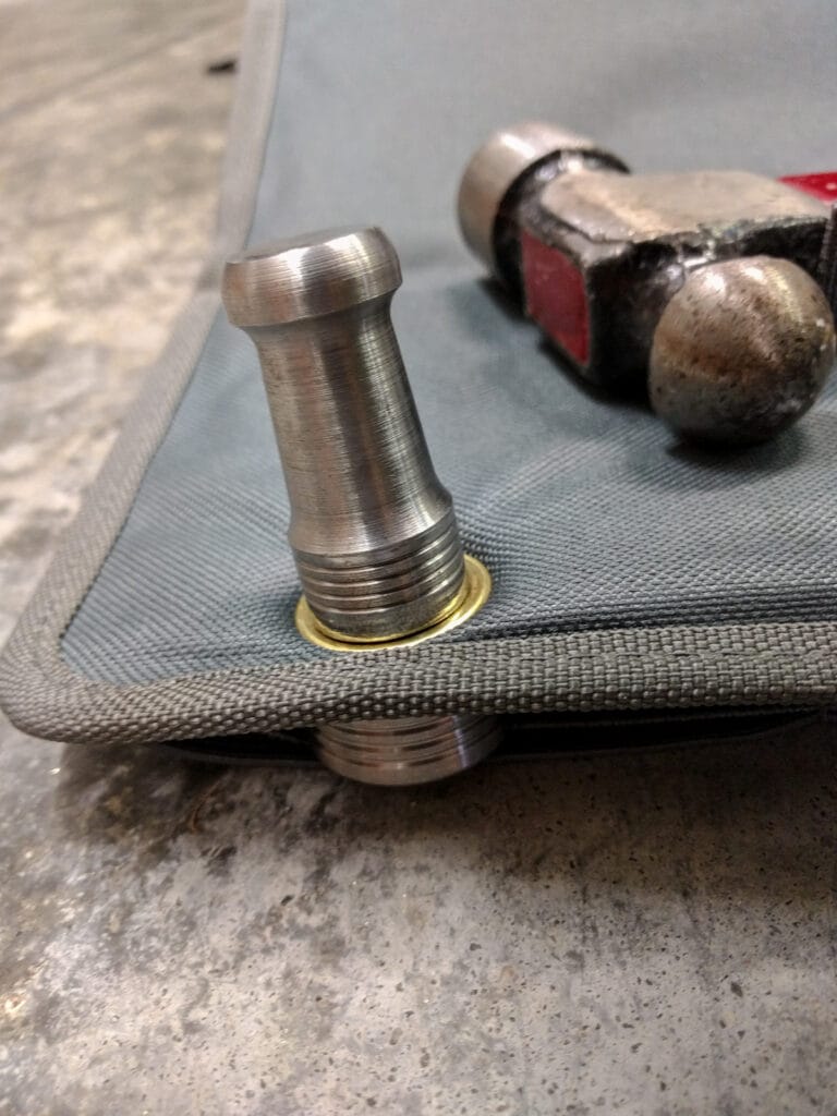 Punching a grommet into the organizer