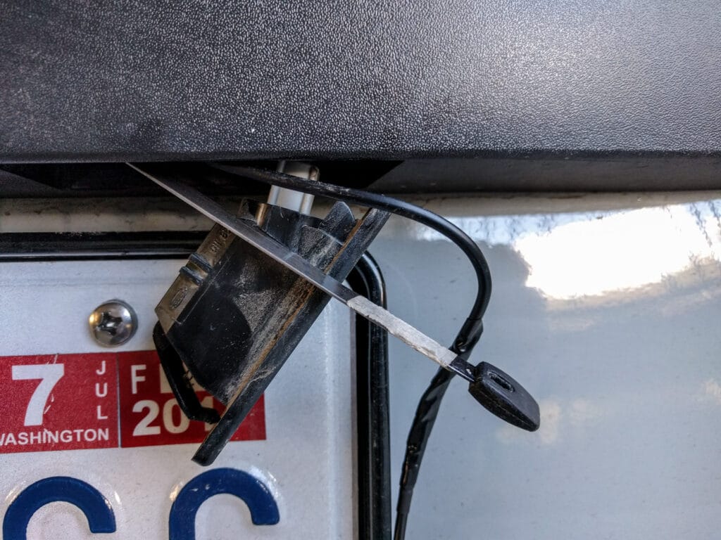 using a wire fish to pull the cable from the inside of the trim to the inside of the rear door