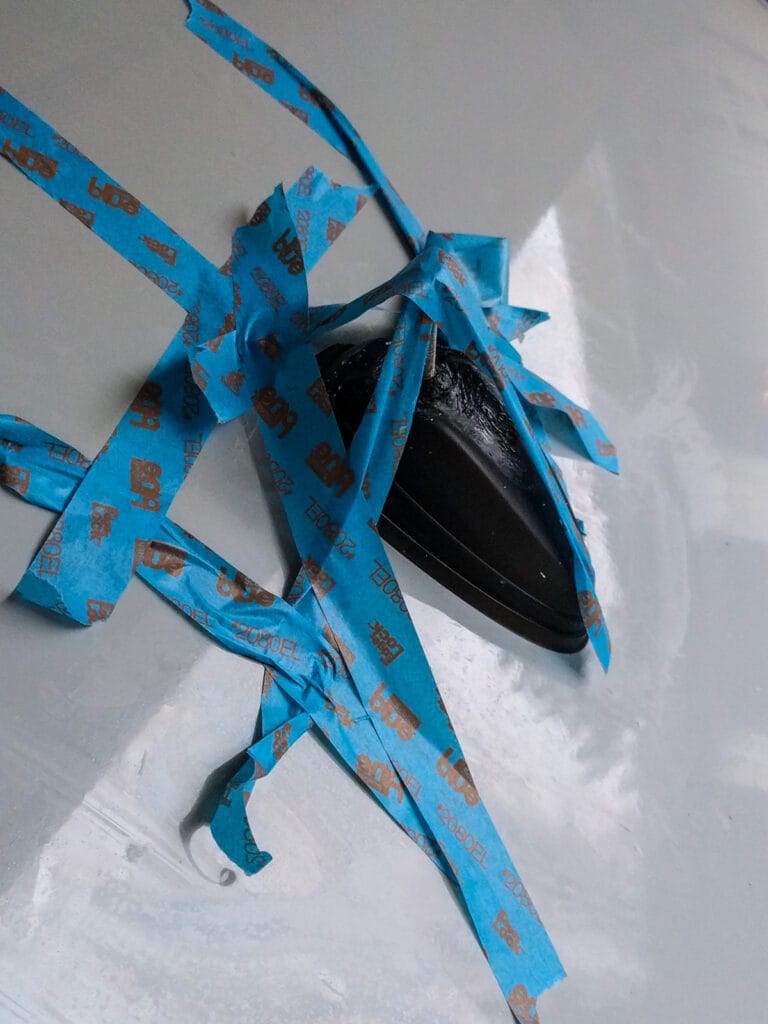 Broken antenna re-glued with masking tape to hold it down