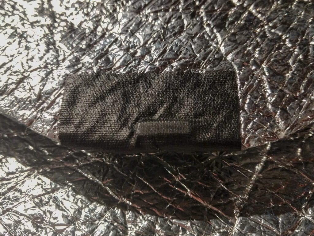 Gaffer tape holding a magnet in place on the edge of a window shade