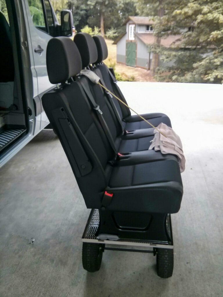 Three-person bench seat strapped to utility cart for transportation