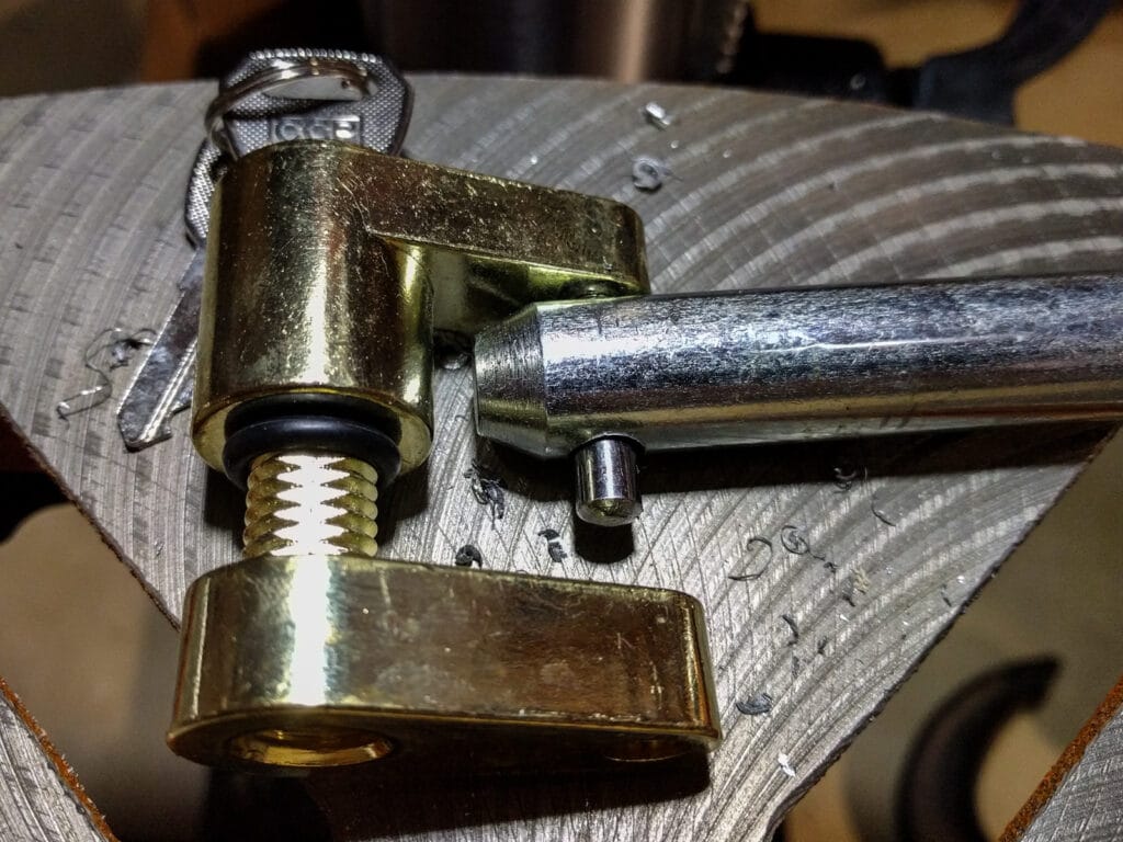 Now the lock fits through the end of the receiver pin