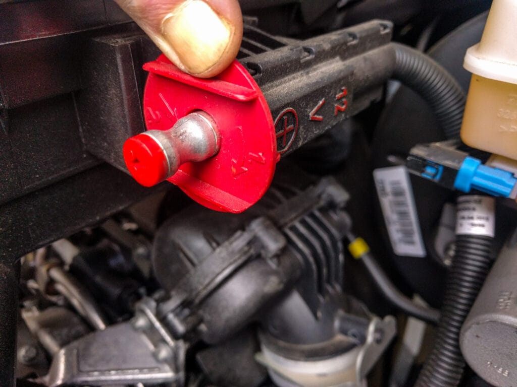 Twist and push to expose the 12v + connection that you'll clip your jump leads to