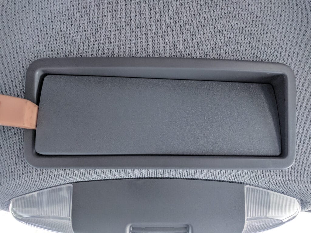 The cover on the overhead cubby levers straight out