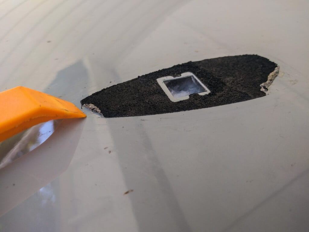 Scrape off the remaining sticky gunk with a plastic tool.