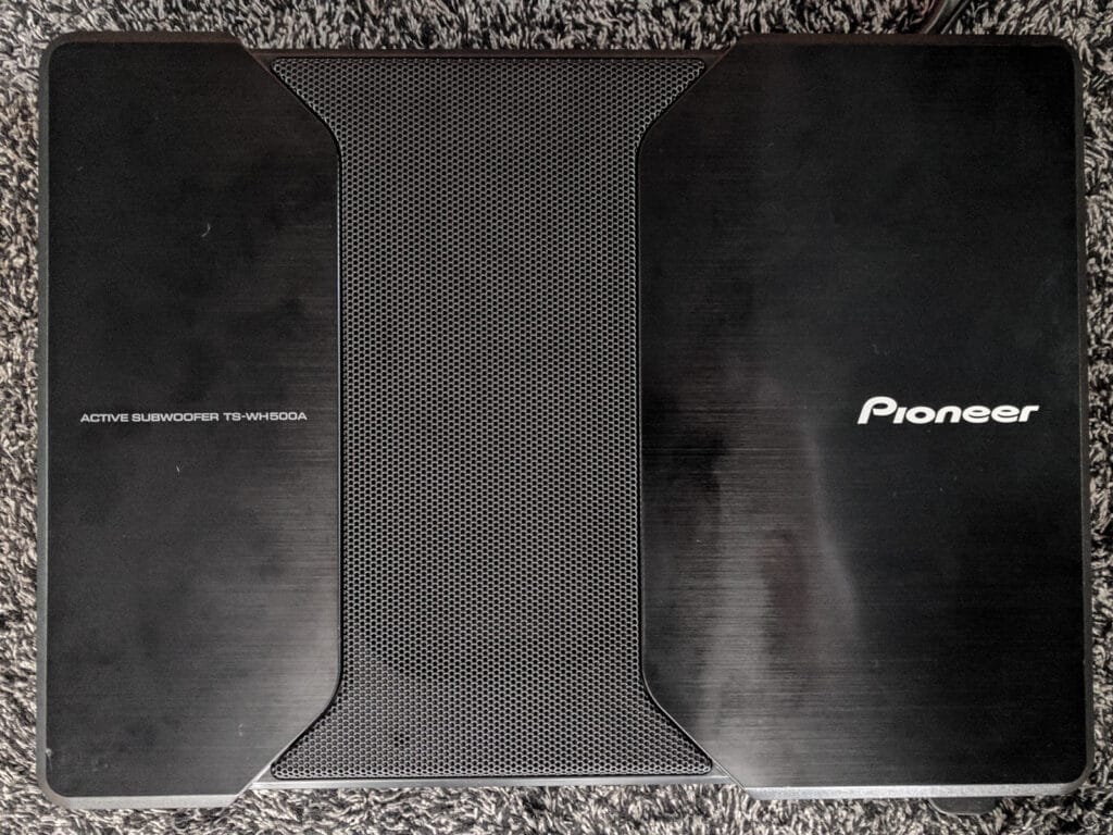 The Pioneer subwoofer we installed behind the driver's seat, hooked up to the output from the center channel speaker