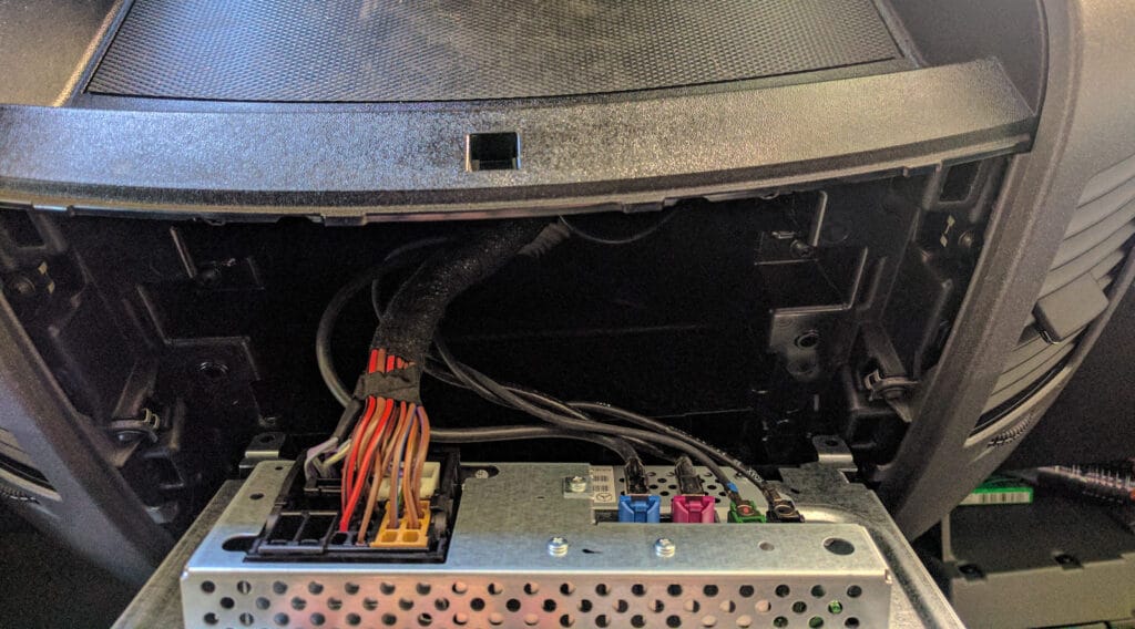 The factory stereo is really shallow. Once you've undone the four screws you can reach behind and unclip the cables.