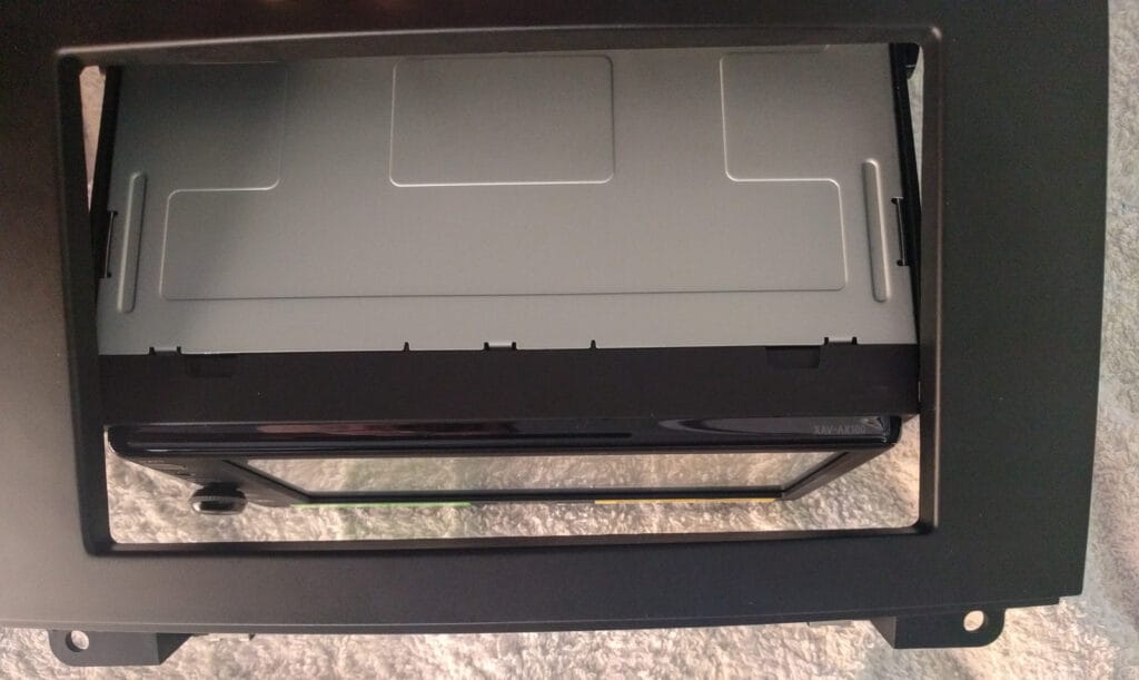 The Sony head unit is wider than the Scosche fascia panel. That means the stereo sits too far back in the housing. Time for some Dremel action!