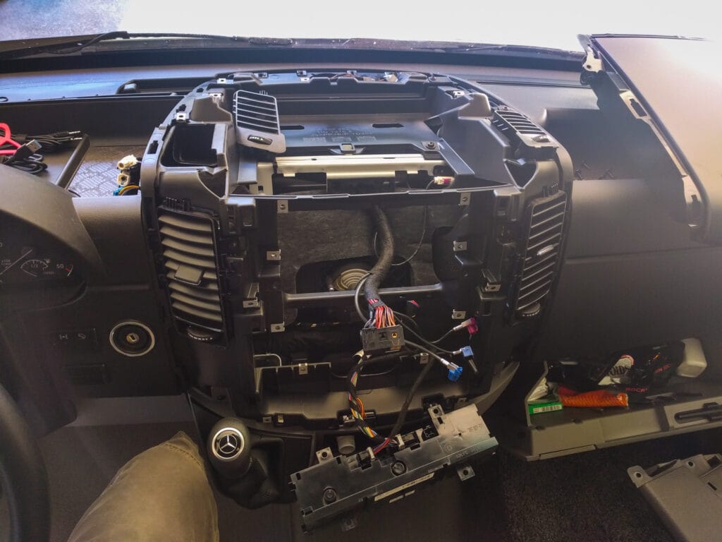 The top tray or shelf is held on with two screws on the front of the console and two on the top. Then it just lifts out.