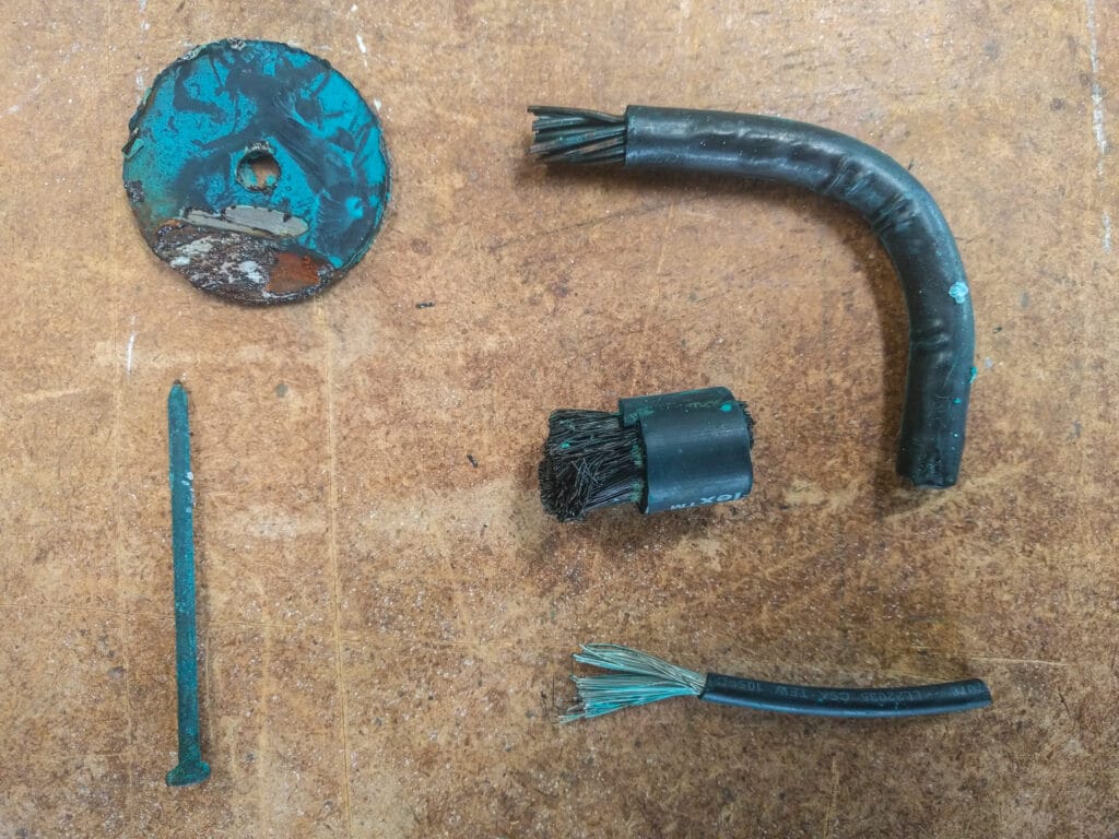 A circle of steel from the van body, a zinc coated steel nail, two untinned pieces of copper cable and (bottom right) tinned copper cable.