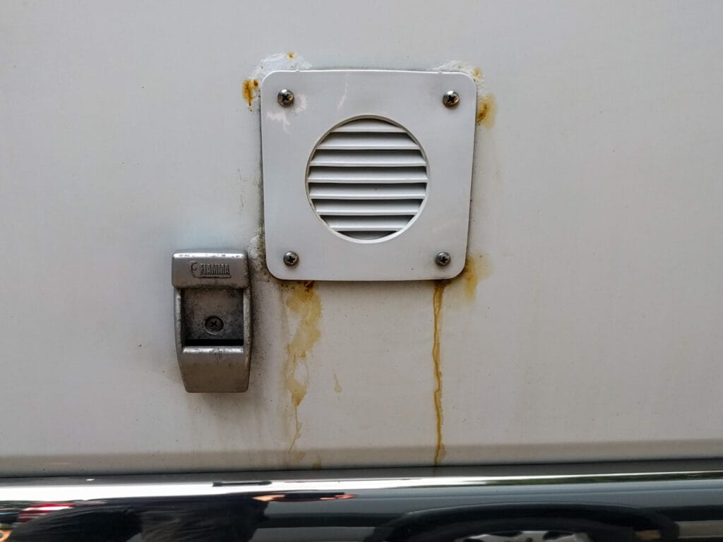 Notice the rust bubbles where the screws enter the van metal. The stainless screws haven't rusted, but the sheet metal they are attached to has.