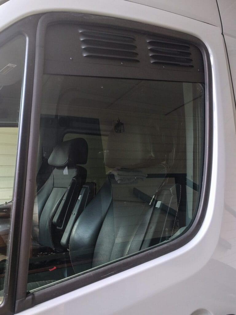 Metal vent in the top of the driver's door window area